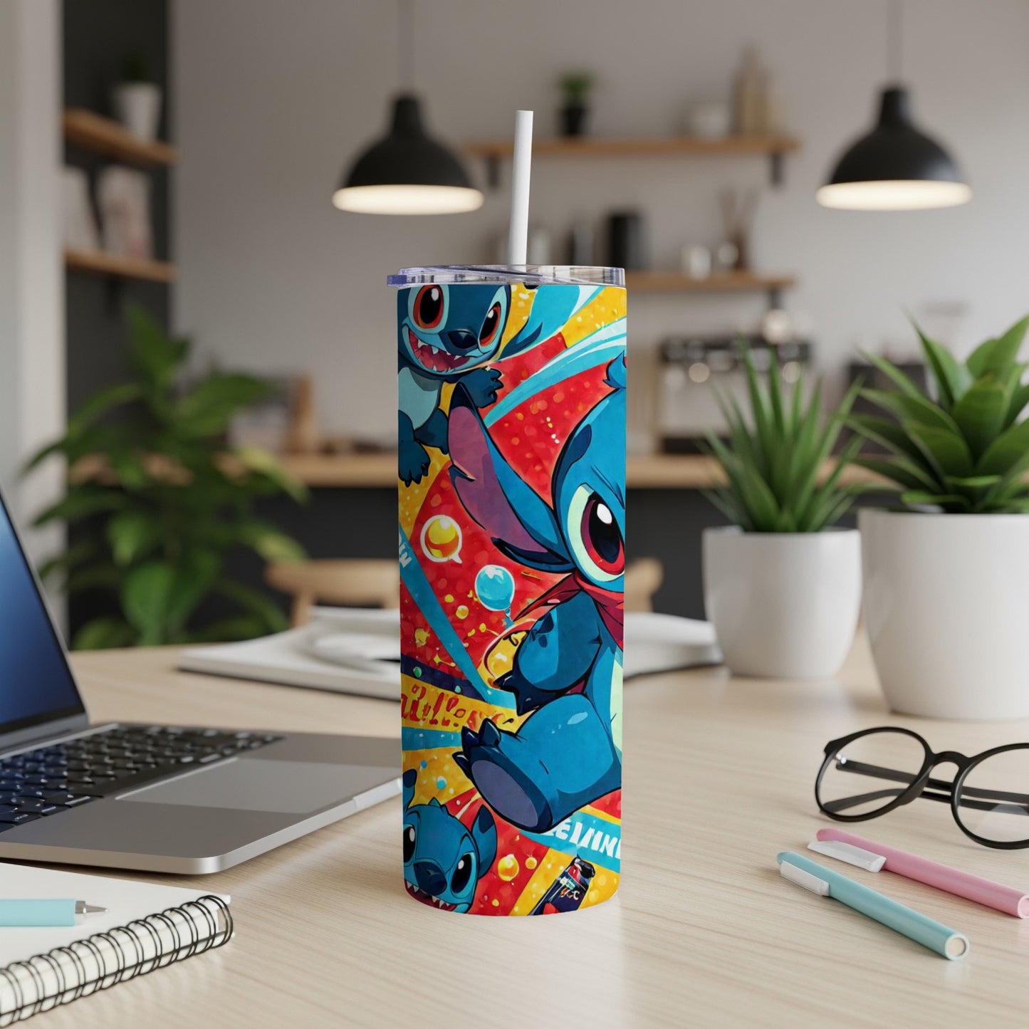 Blue Stitch character on a colorful tumbler with straws and pens on a desk.