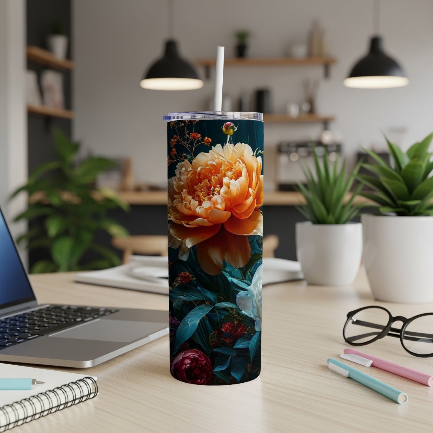 Orange peony and dark floral pattern on a stainless steel tumbler.