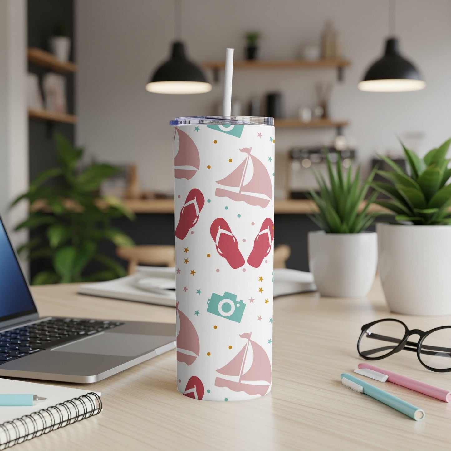 White tumbler with pink sailboats, flip-flops, and stars pattern.