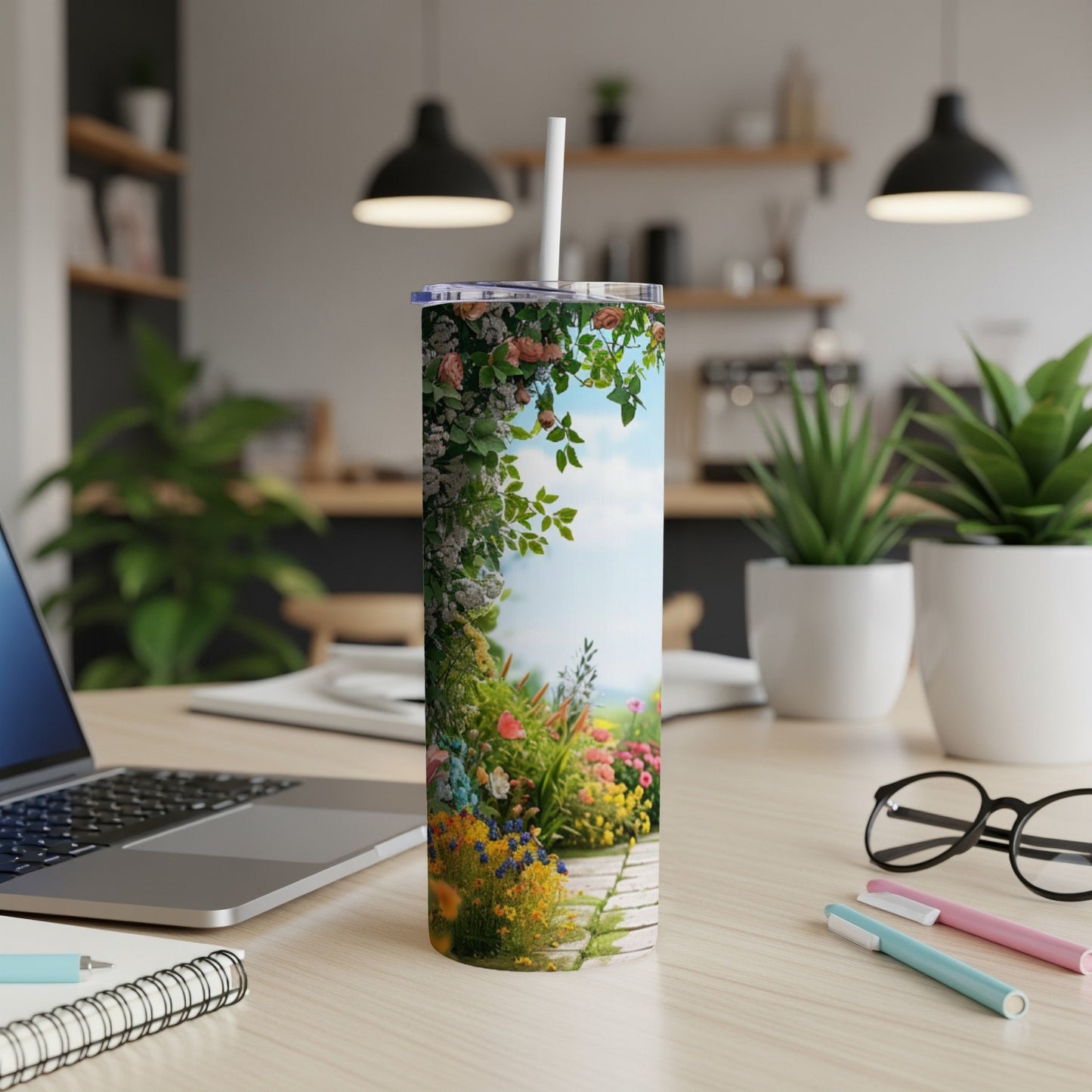 Floral garden scene on a white tumbler with a straw.