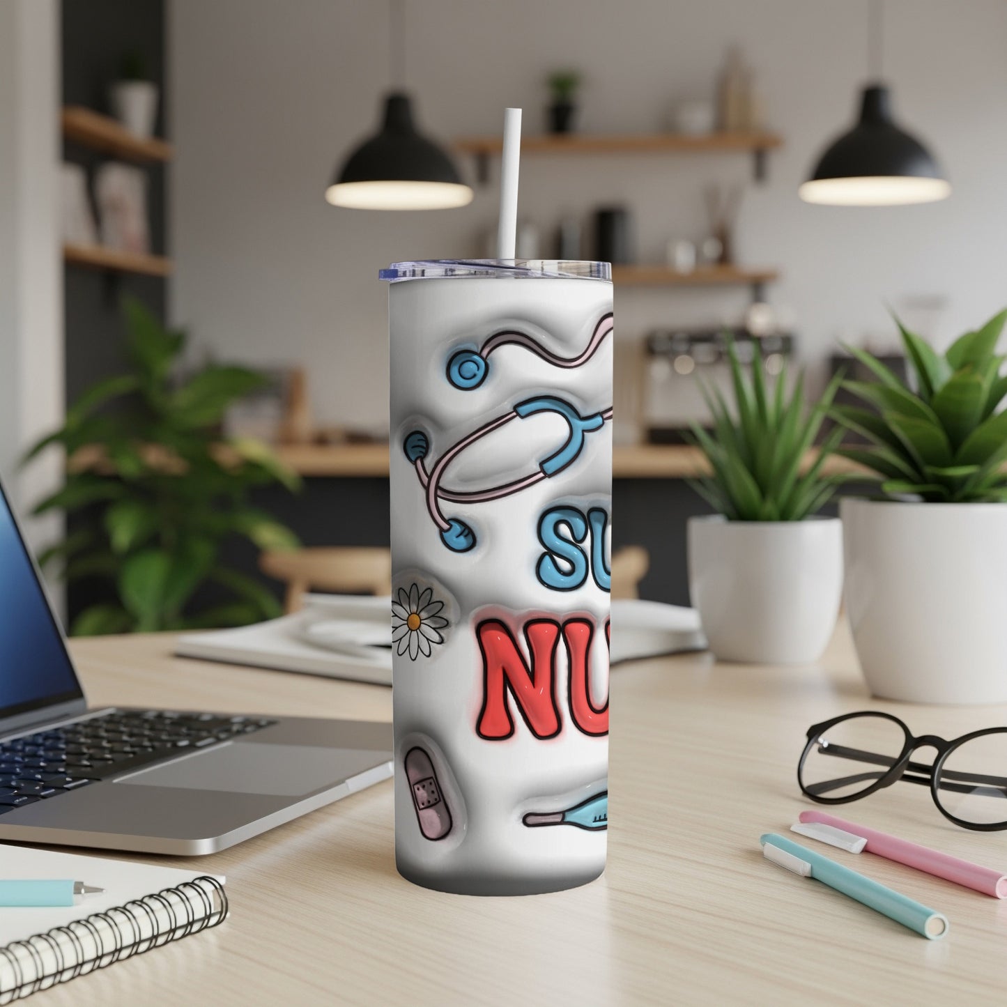 White tumbler with "Super Nurse" text and medical icons on desk.