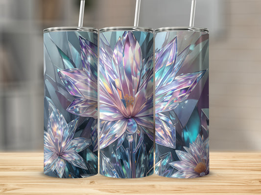 Three tumblers with crystal flower designs sit on a wooden surface.