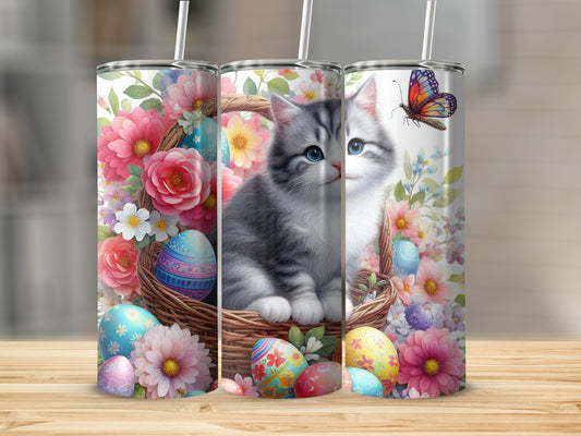 Kitten in a basket with Easter eggs and flowers, butterfly.
