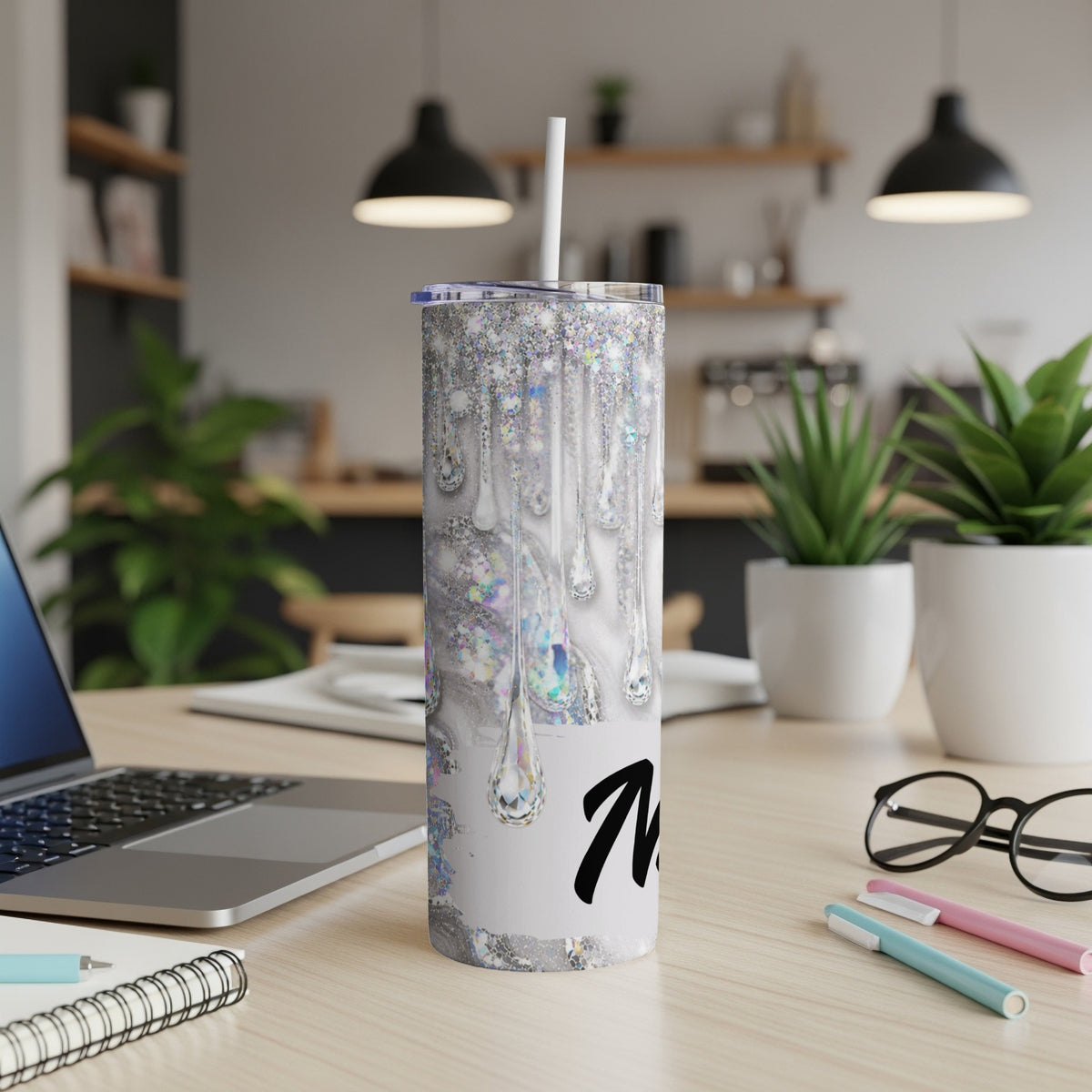 Glitter drip tumbler with a black letter "M" on a white background.