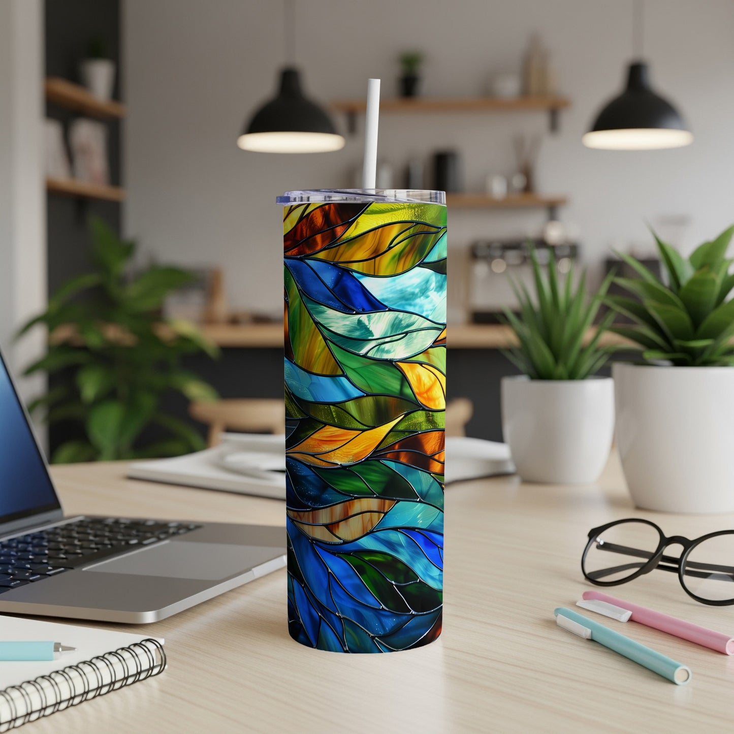 Colorful stained glass pattern on a white insulated tumbler with a straw.
