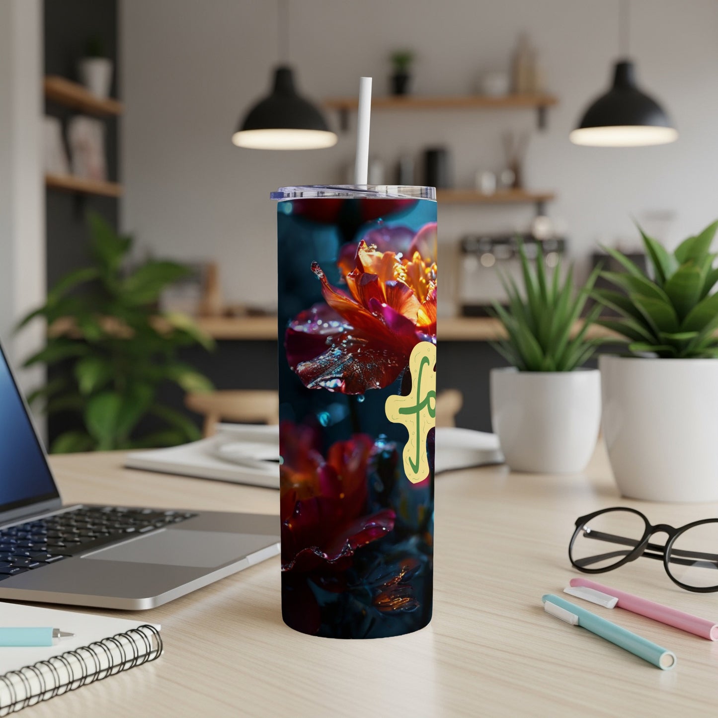 Tumbler with yellow floral design and water droplets on dark background.