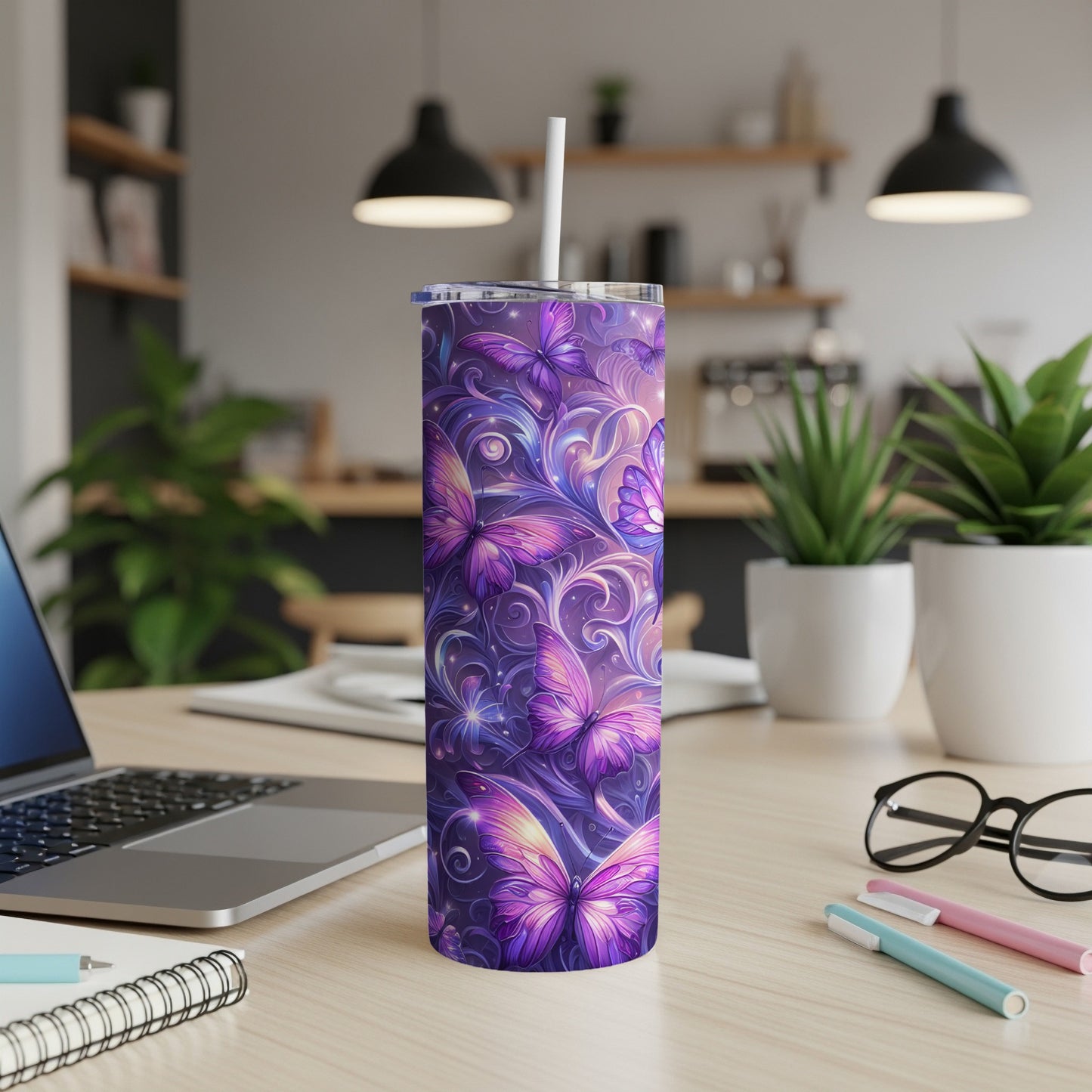 Purple floral butterfly tumbler with white straw on desk.