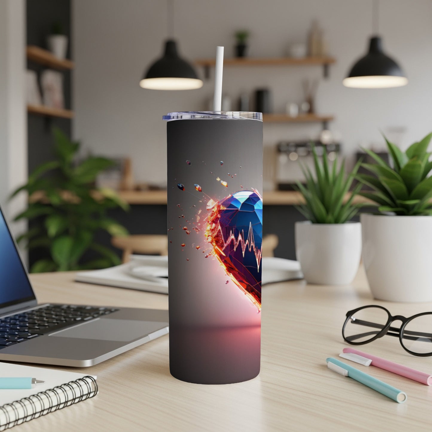 Heart-shaped gem tumbler with a pulse line design on a desk.