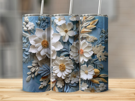 Three tumblers with white floral relief patterns on a textured blue background.