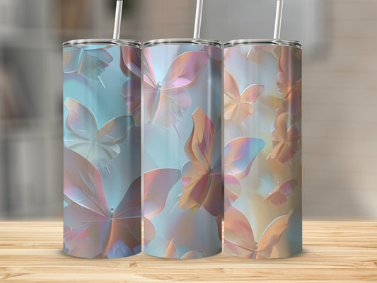 Three tumblers with iridescent butterfly patterns on a wooden surface.