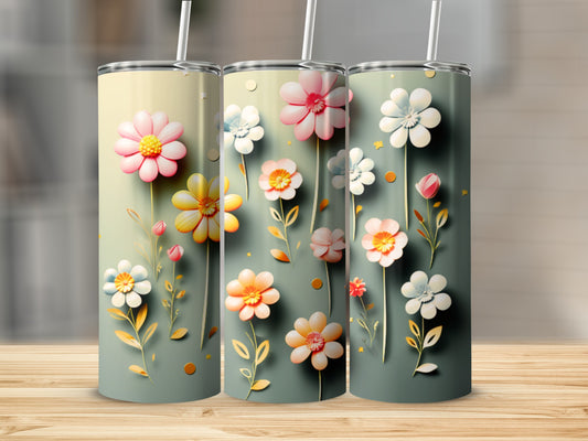 Three tumblers with pastel floral designs and straws on a wooden surface.
