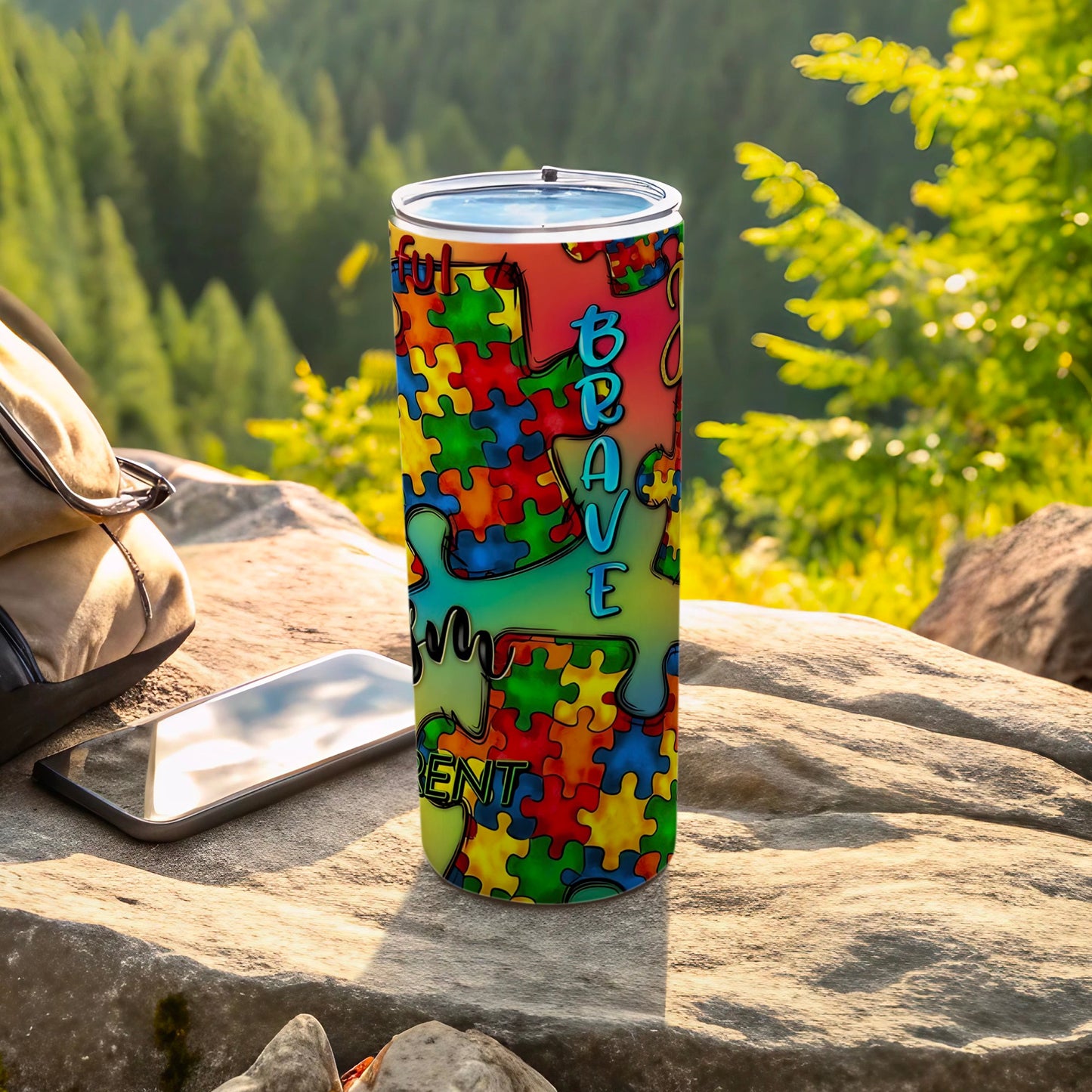 Colorful puzzle piece tumbler with "Brave and Resilient" text.