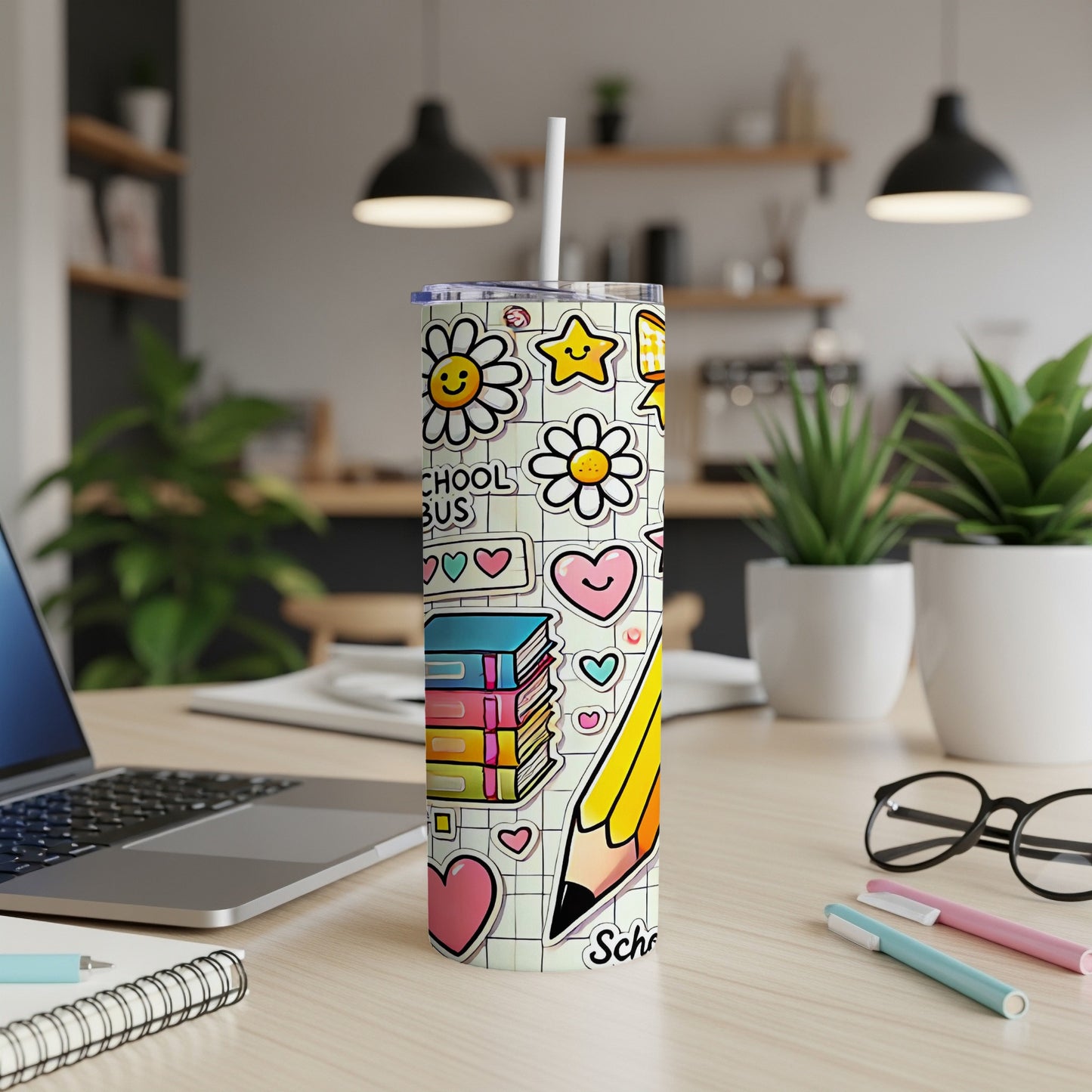Tumbler with cartoon school supplies, flowers, and hearts, including a large pencil.