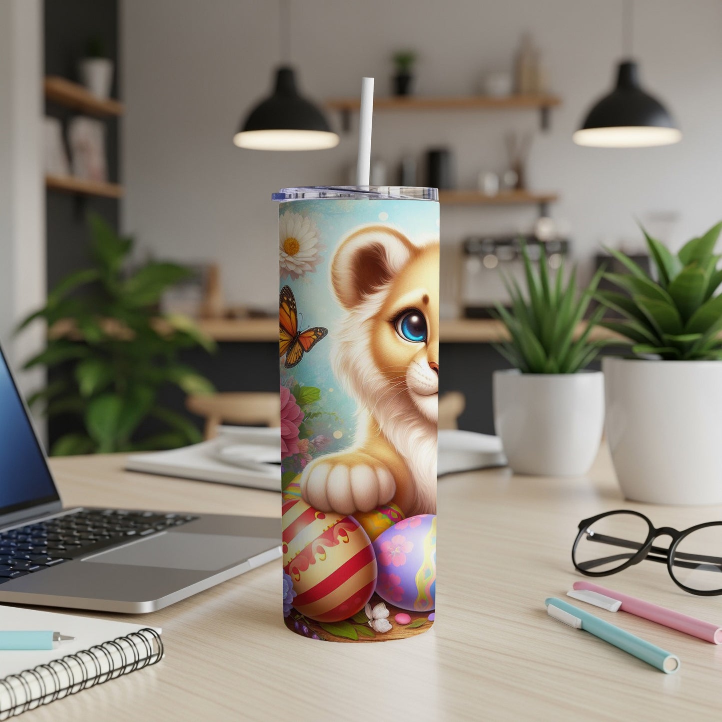 Lion cub with Easter eggs and butterfly on a tumbler with a straw.