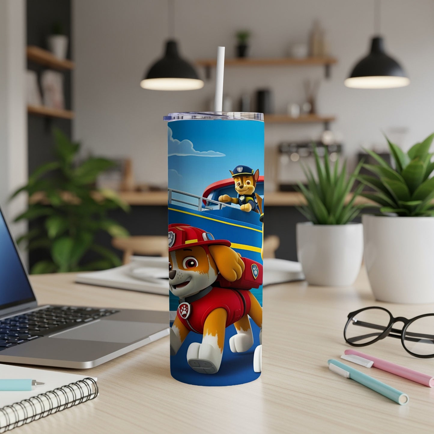 Paw Patrol Marshall and Chase on a blue tumbler with a laptop and supplies.