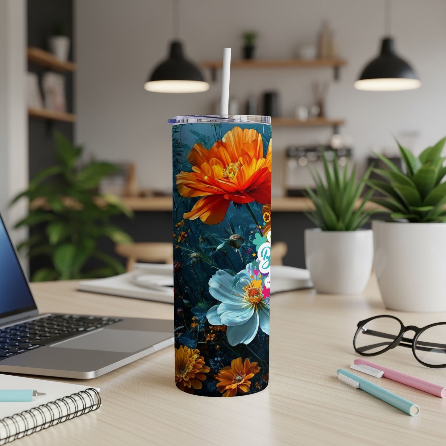 Tall tumbler with vibrant floral design on a desk.
