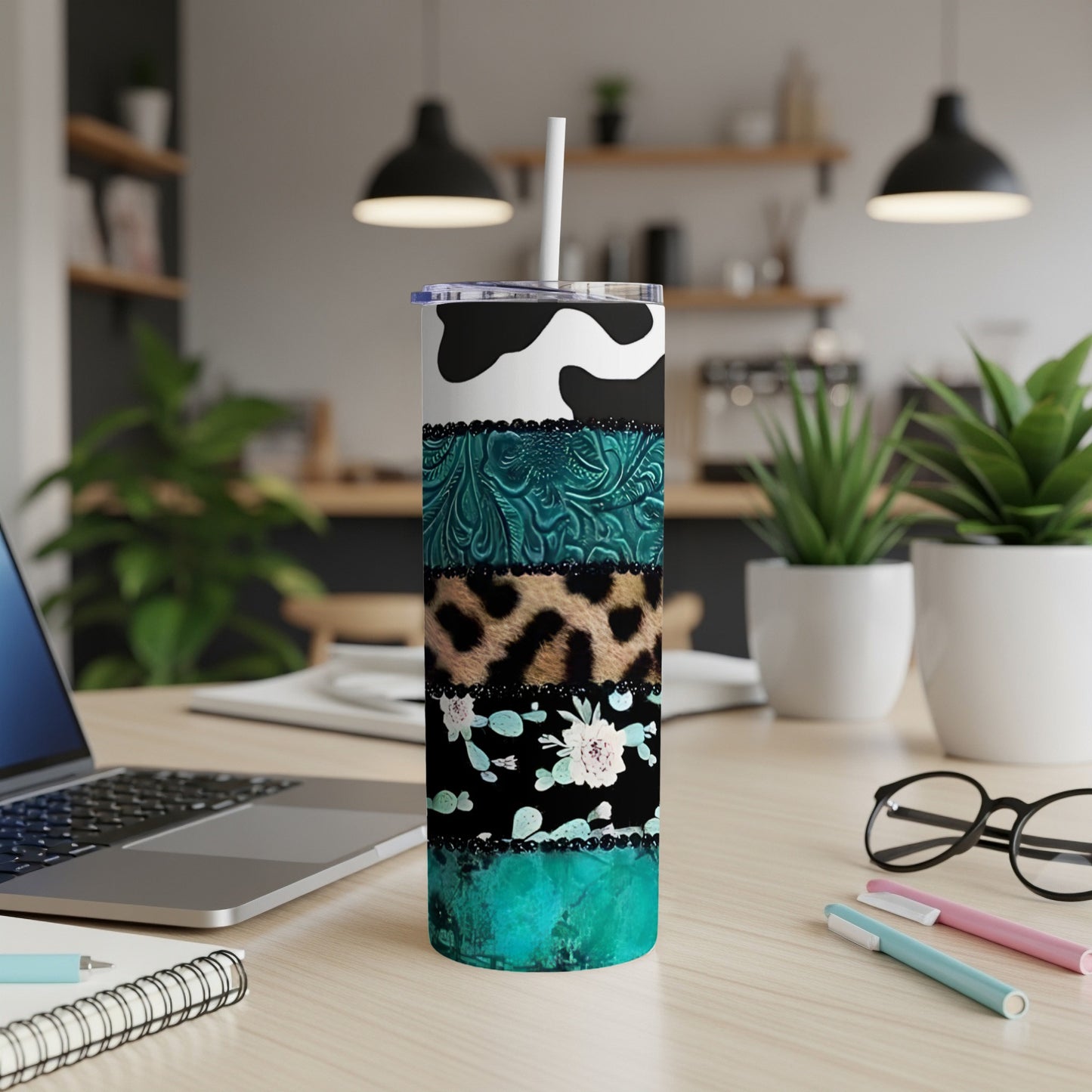 Tall tumbler with cow print, teal embossed, leopard print, and floral patterns.
