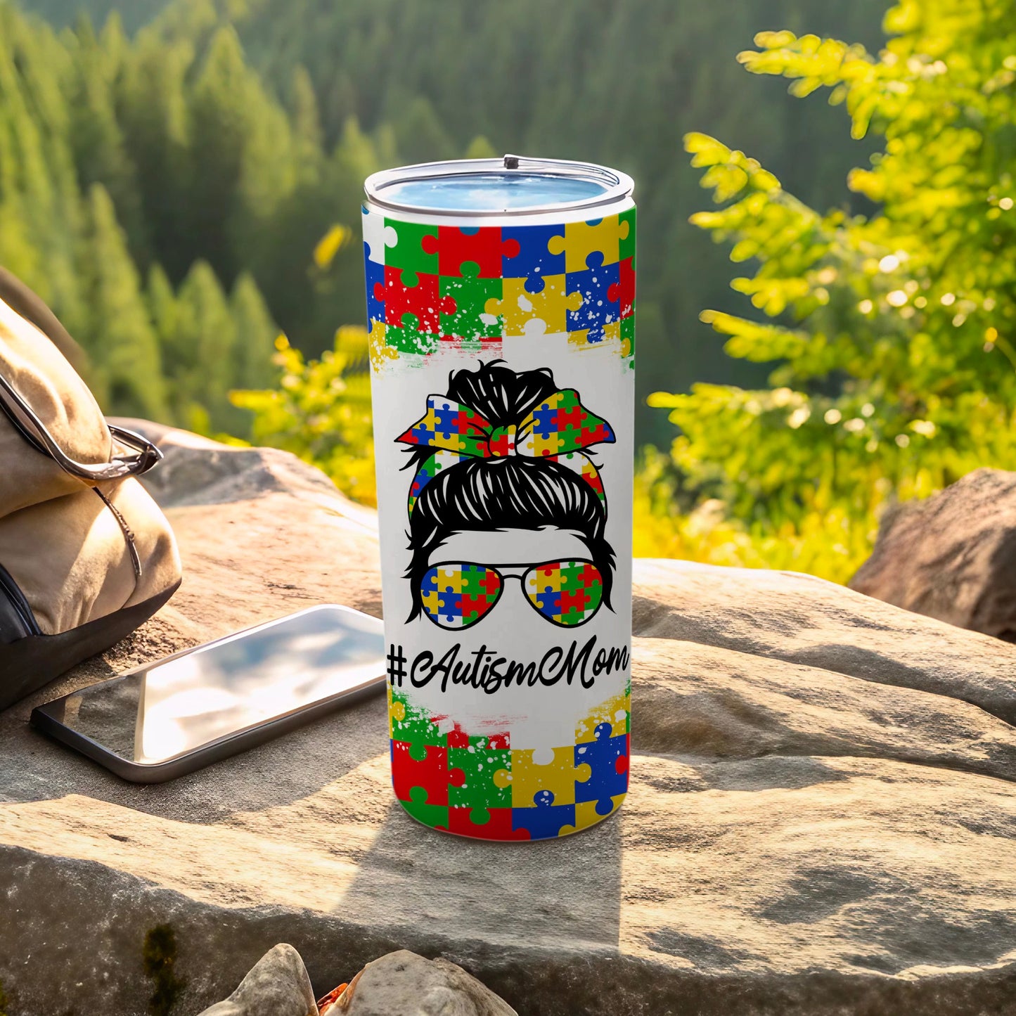 Autism Mom tumbler with colorful puzzle pieces and sunglasses.