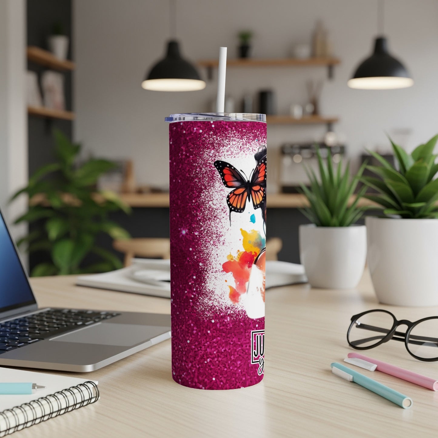 Glittery pink tumbler with butterflies and "Just A Girl" text.