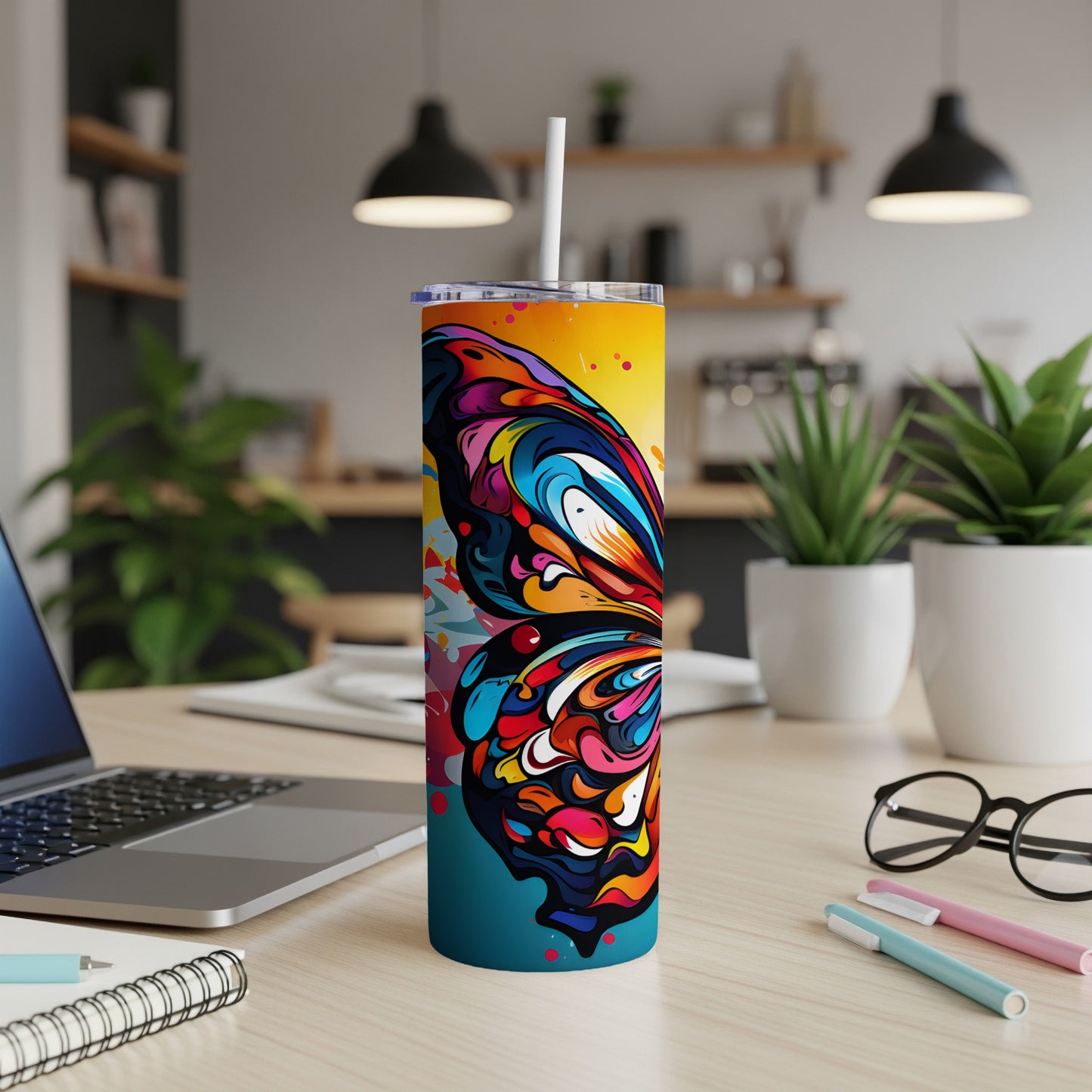 Colorful butterfly design on a stainless steel tumbler with straw.