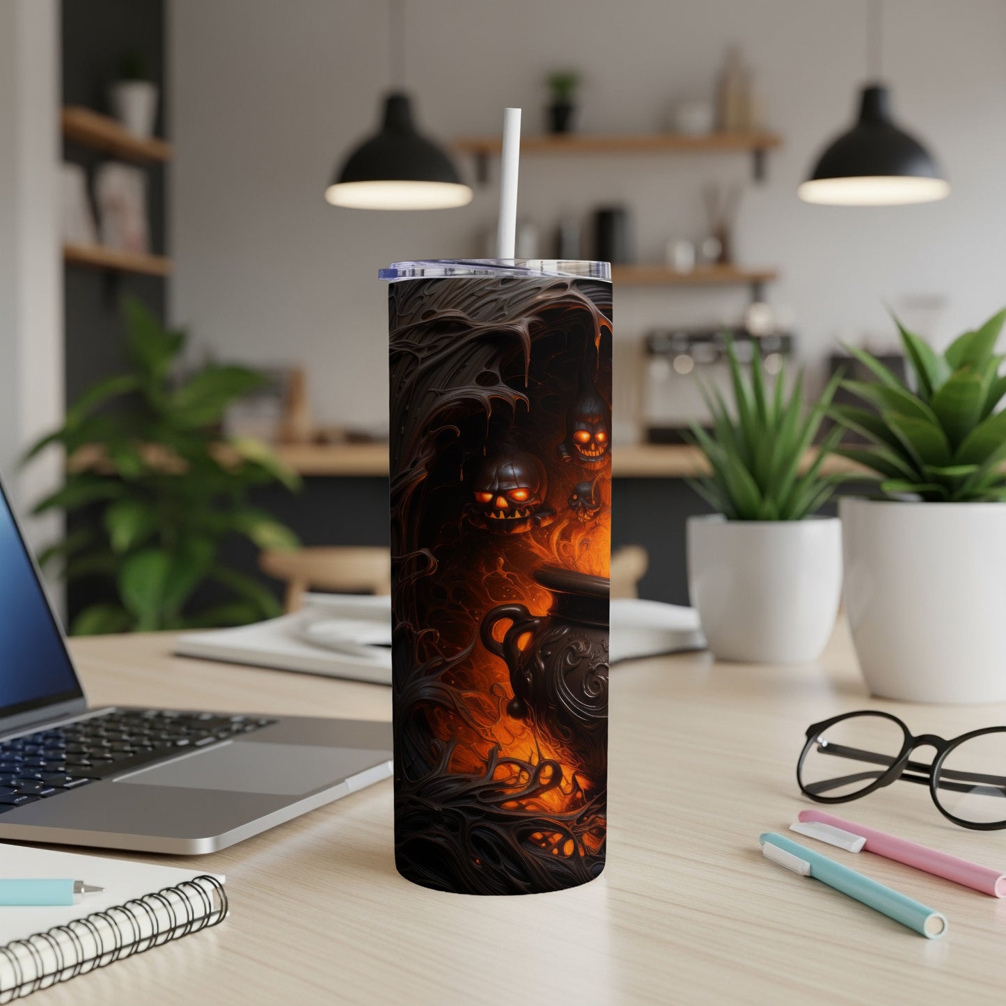 Tumbler with a spooky Halloween scene of skulls and a cauldron with fire.