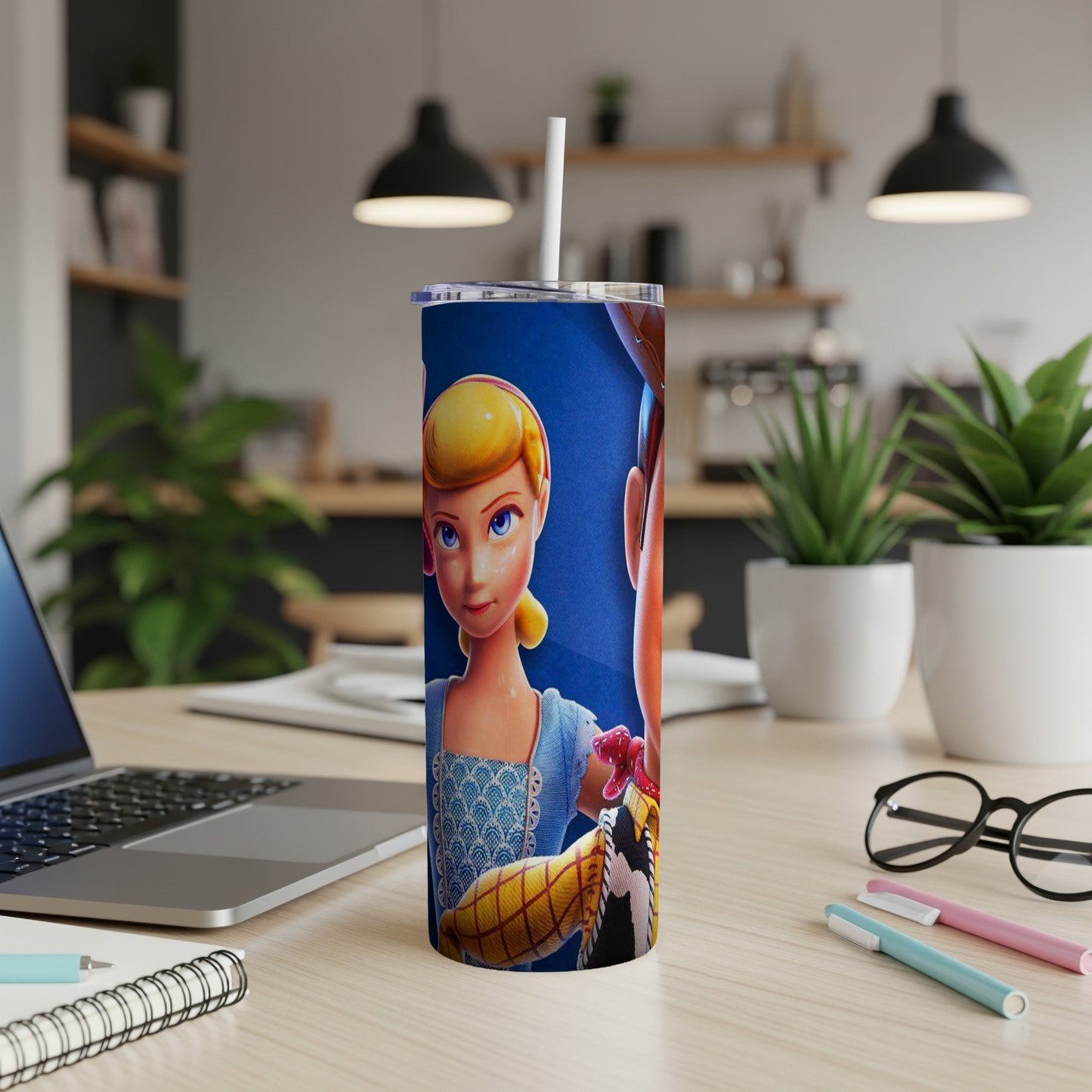 Bo Peep and Woody characters on a blue tumbler with a white straw.