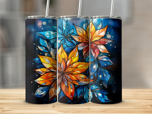 Three tumblers with colorful stained-glass floral designs on a wooden surface.