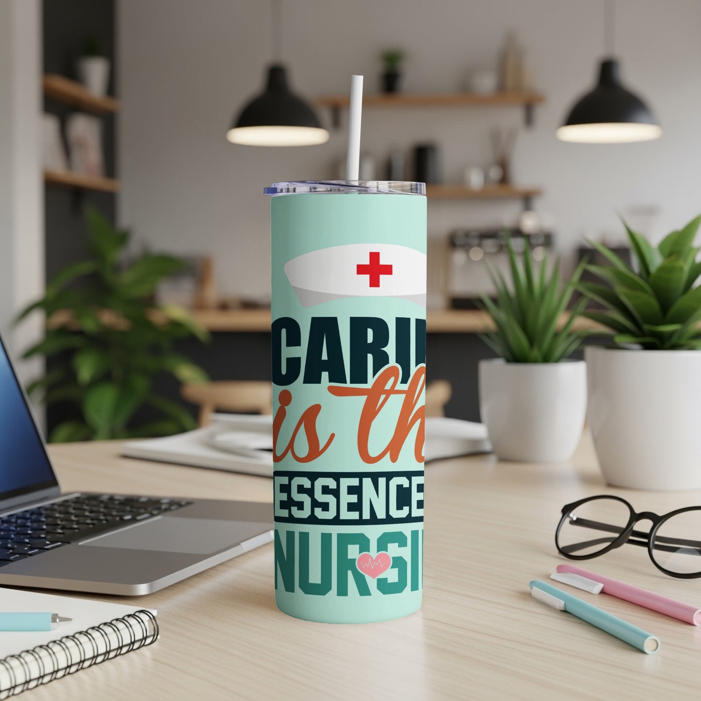 Mint tumbler with "CARING is the ESSENCE of NURSING" and a red cross.