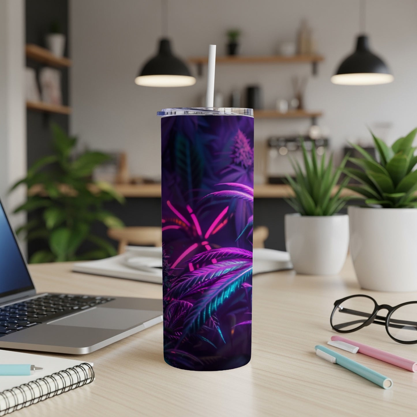 Purple and blue cannabis leaf design on a tumbler with a white straw.