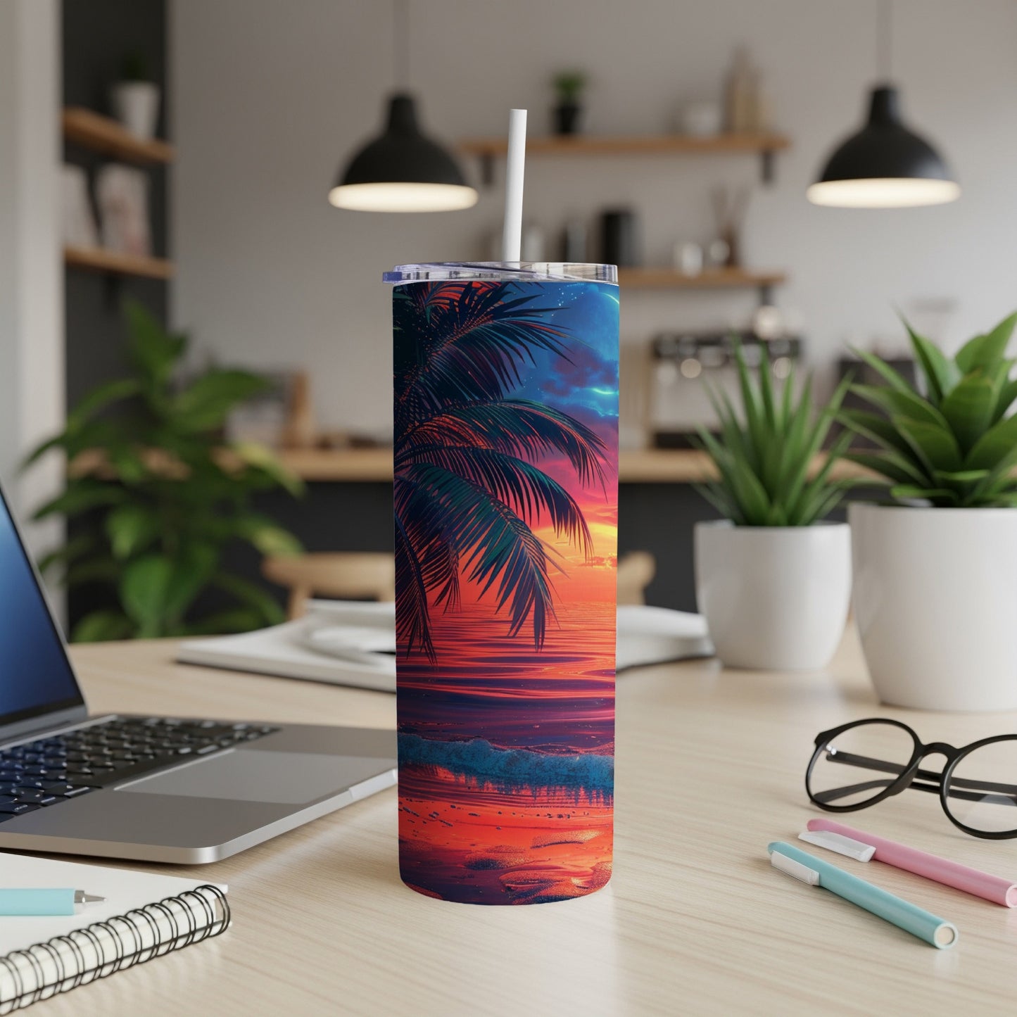 Tumbler with sunset over ocean waves and palm fronds.