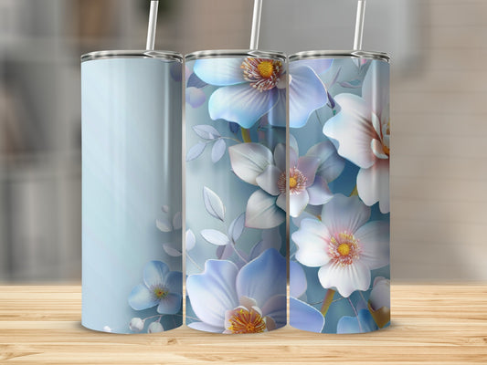 Three tall tumblers with blue and white floral designs on a wooden surface.