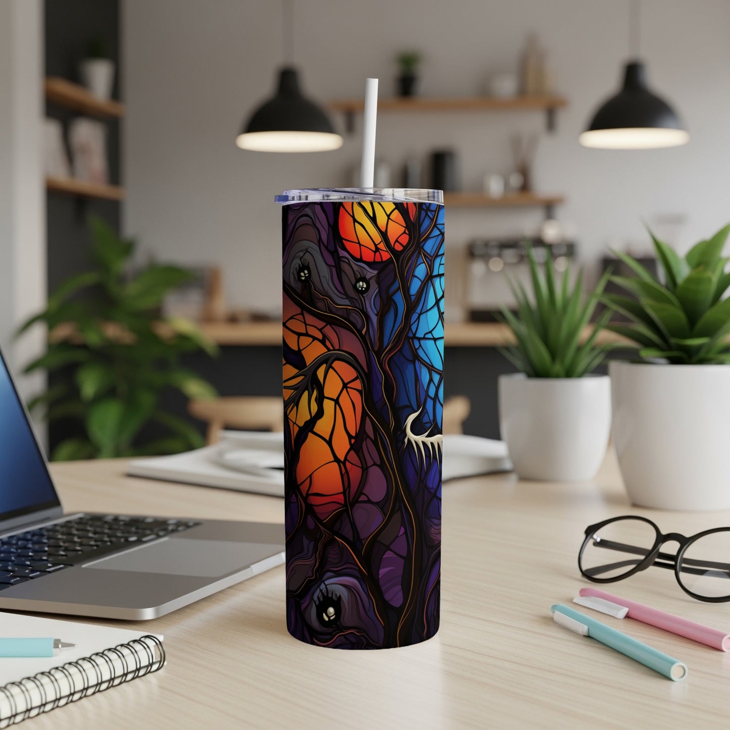 Tall tumbler with a spooky, colorful Halloween tree and moon design.