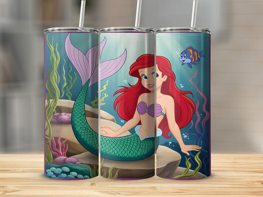 Ariel the mermaid and a blue fish underwater, surrounded by plants and rocks.