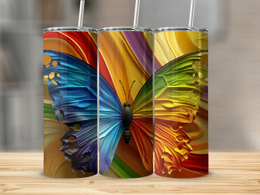 Three tumblers with colorful butterfly wings on a wooden surface.