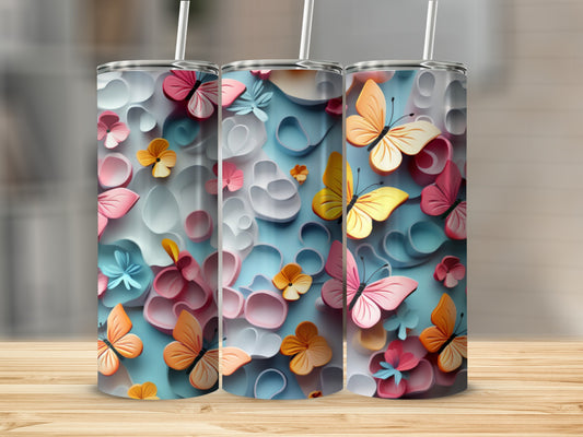Three tumblers with pastel butterflies and floral designs on a wooden surface.