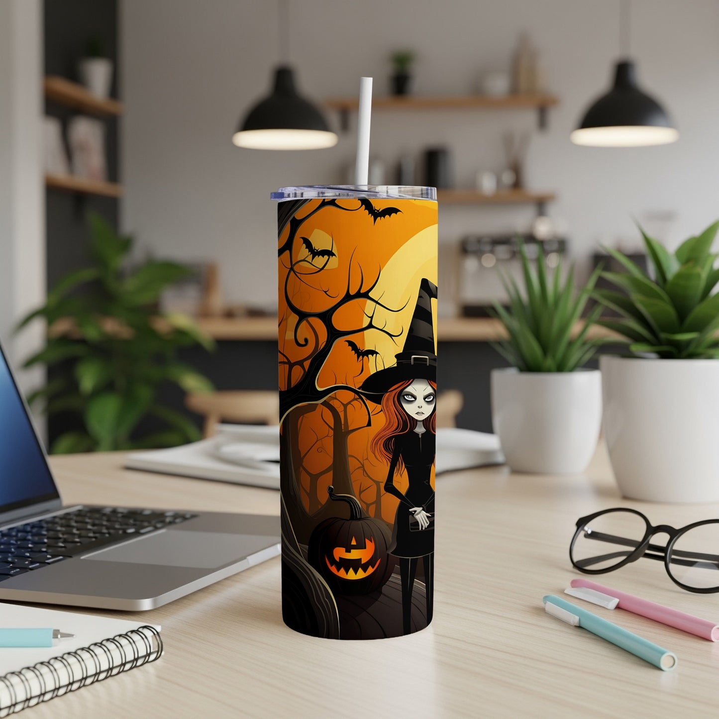 Halloween tumbler with witch, pumpkin, bats, and spooky trees on orange background.