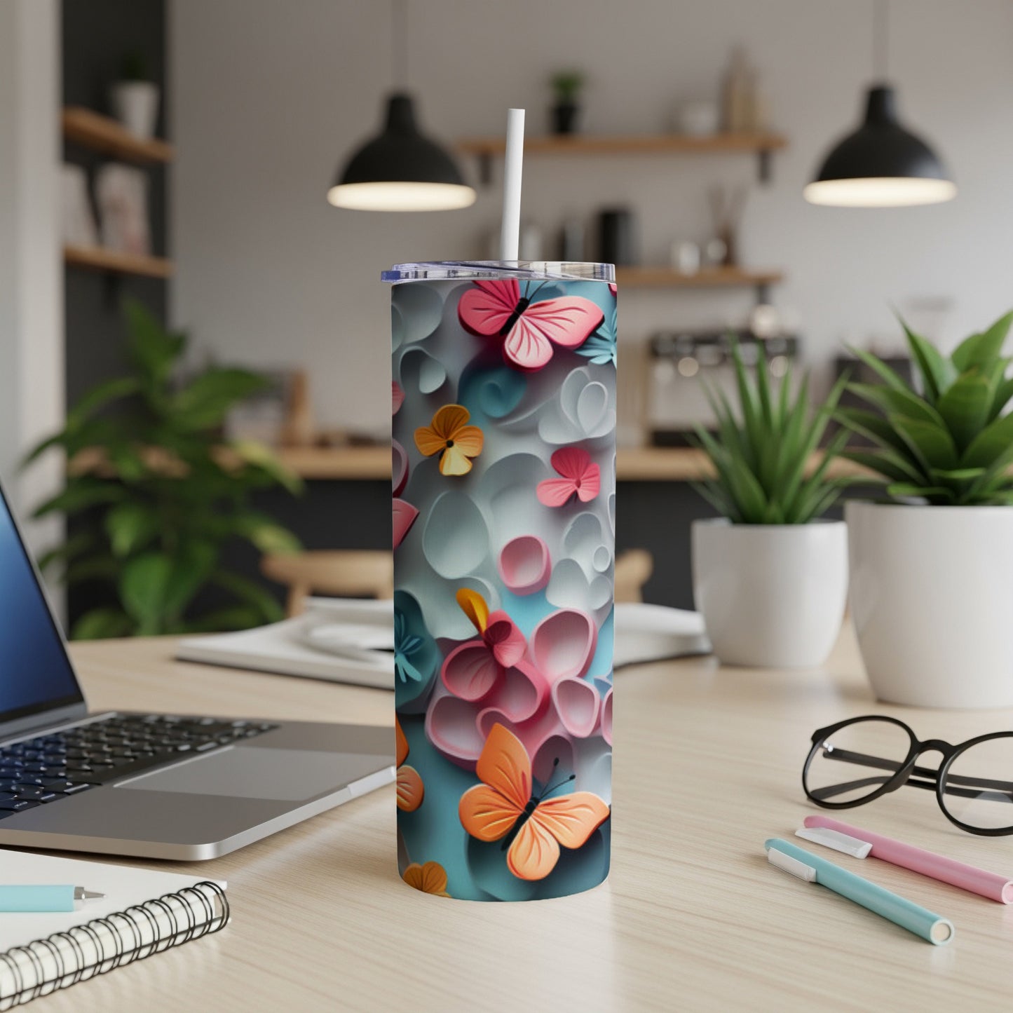 Tumbler with colorful butterflies and floral design.
