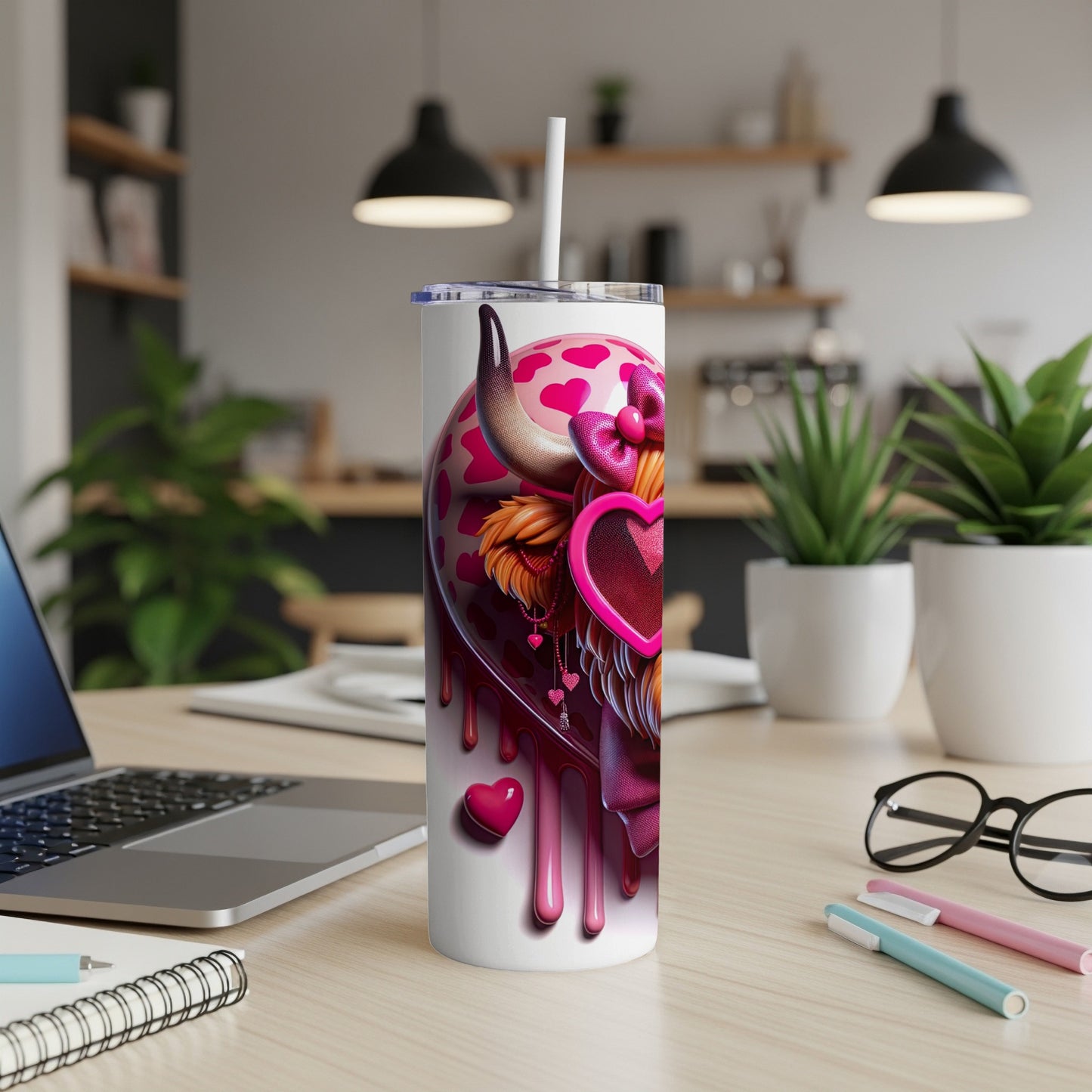 White tumbler with pink hearts, cow spots, and pink bow.