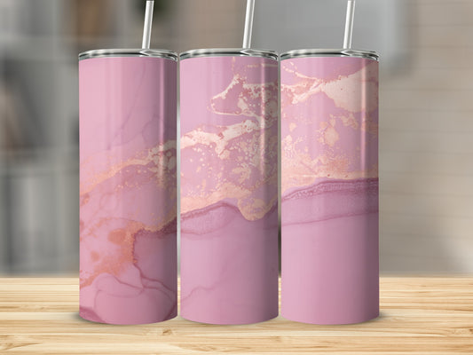 Three pink tumblers with rose gold marble pattern on wooden surface.