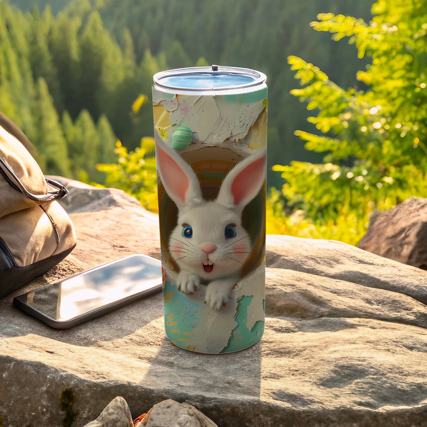 Easter bunny tumbler with colorful design, resting on a rock outdoors.