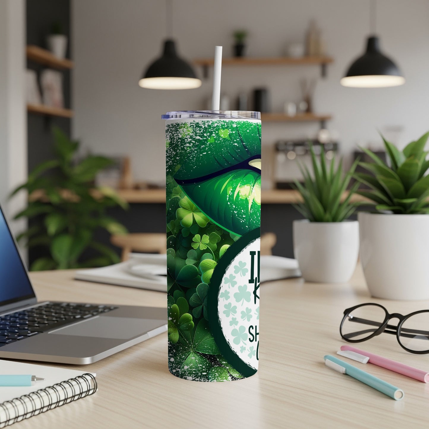 Green shamrock tumbler with white straw and "Lucky Charm" text.