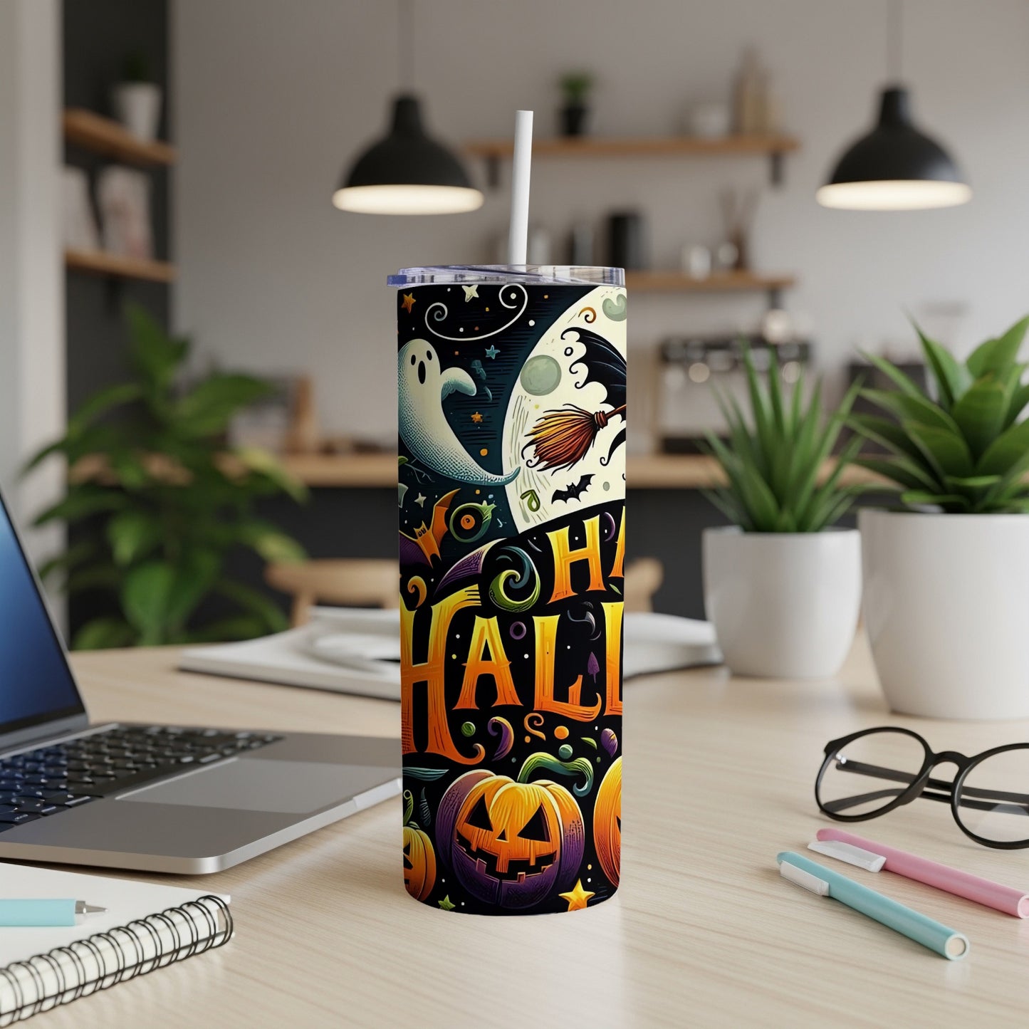 Halloween tumbler with ghosts, pumpkins, and moon design, featuring a straw.