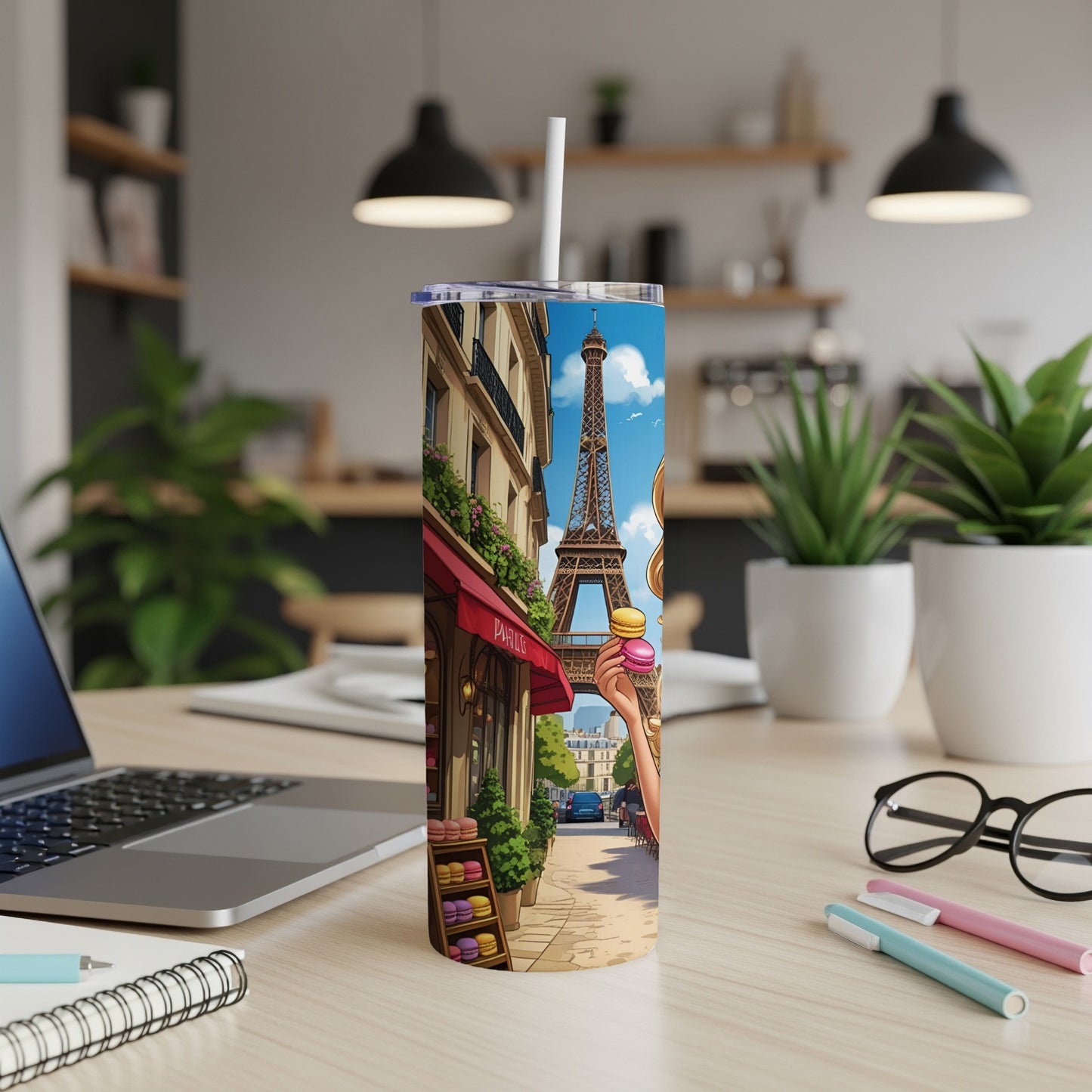 Parisian street scene with Eiffel Tower and macarons on a tumbler.