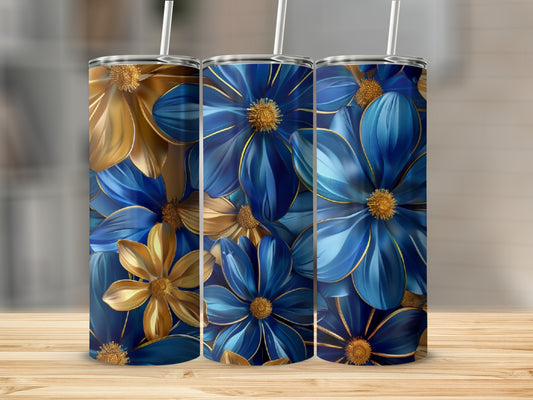 Three blue and gold floral tumblers with straws on a wooden surface.