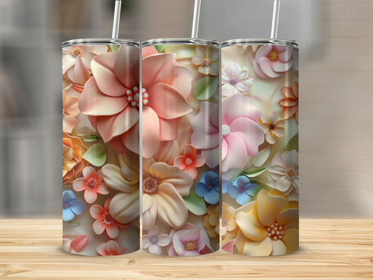 Three floral tumblers with pastel flowers and leaves on a wooden surface.