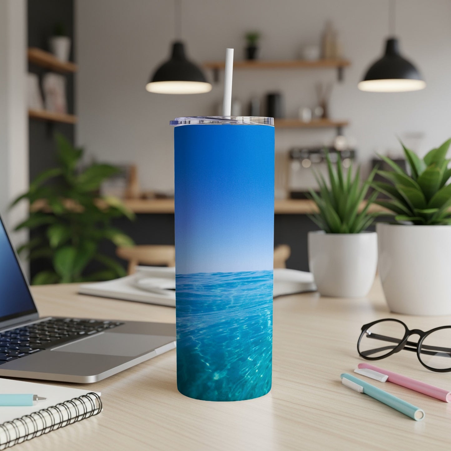 Blue ocean water texture on a blue tumbler with white straw.