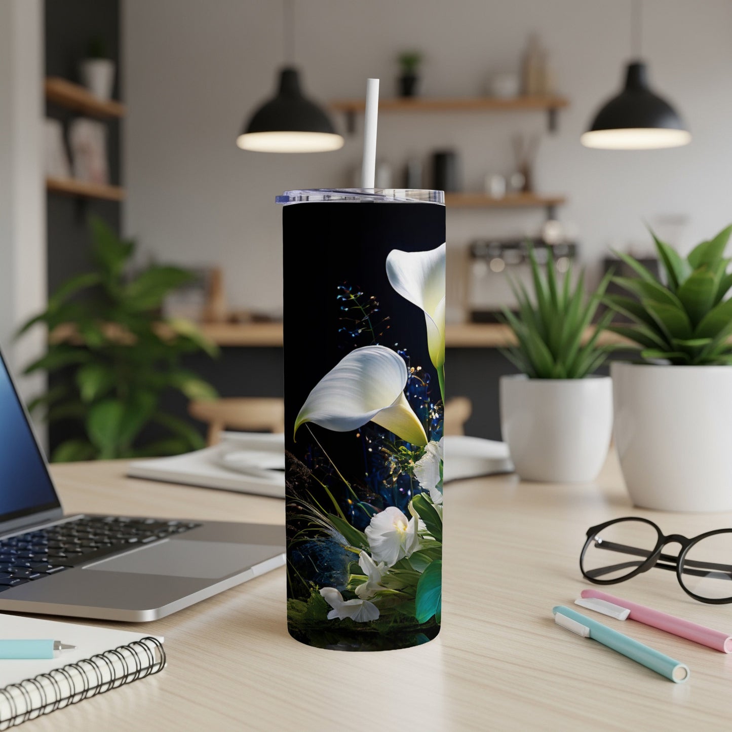 Black tumbler with white calla lilies and green foliage.