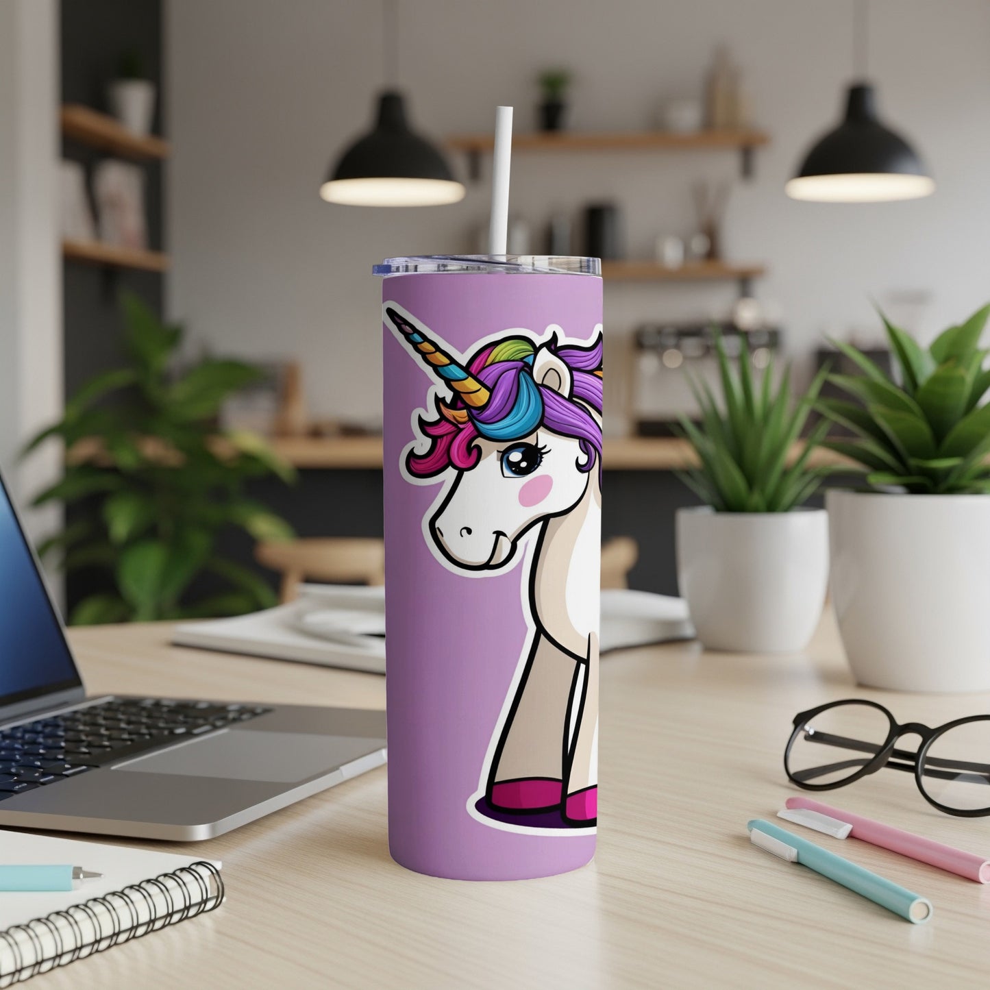 Purple tumbler with a cartoon unicorn graphic, lid, and straw.