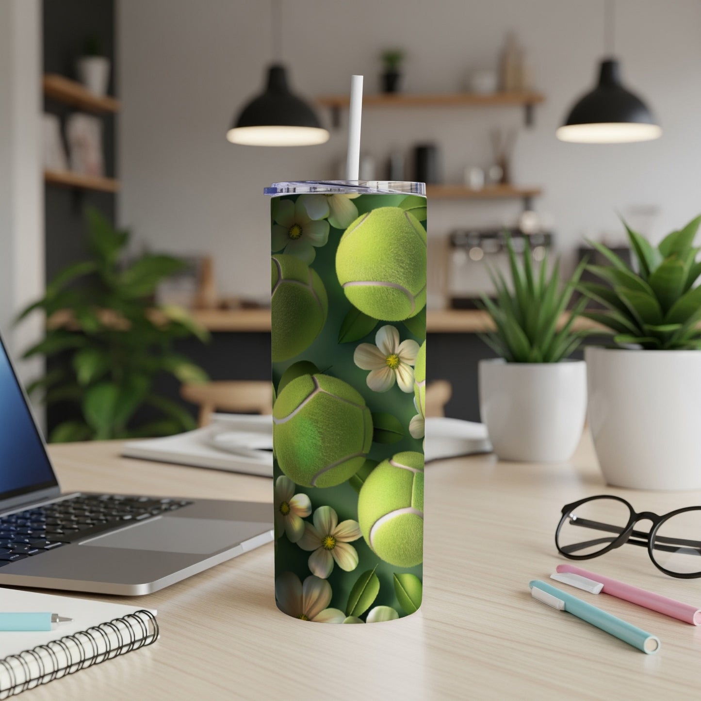 Green tennis balls and white flowers pattern on a white tumbler.