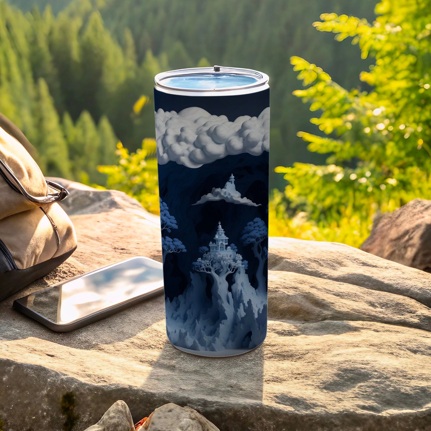 Blue tumbler with fantastical mountain landscape and castle illustration.
